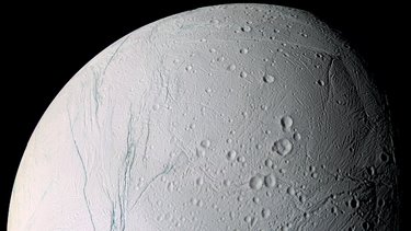 Enceladus as viewed from NASA’s Cassini spacecraft. Gravity measurements taken by the craft align with the presence of a sea 20 to 25 miles below the moon’s surface, scientists say.