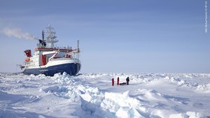 Polarstern drifting in the arctic ice with scientists in the front on the right side